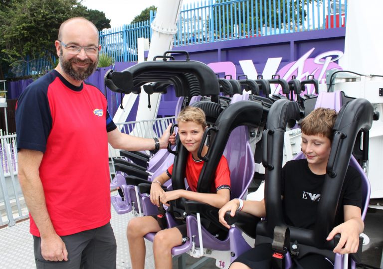 MP James Duddridge straps in Jamie Man (11), left, and Charlie Dacosta (11), right, while working on white-knuckle ride Axis